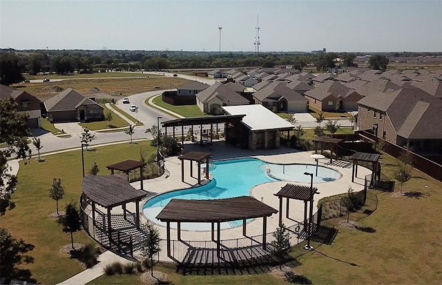 community pool with a patio, a gazebo, fence, and a residential view