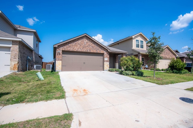 view of front of property featuring a garage, a front yard, and central AC