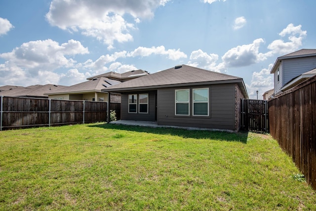 back of property featuring a patio and a lawn