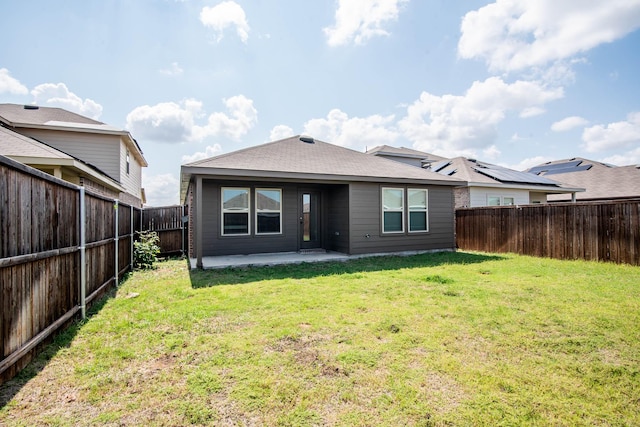 rear view of property with a lawn and a patio area