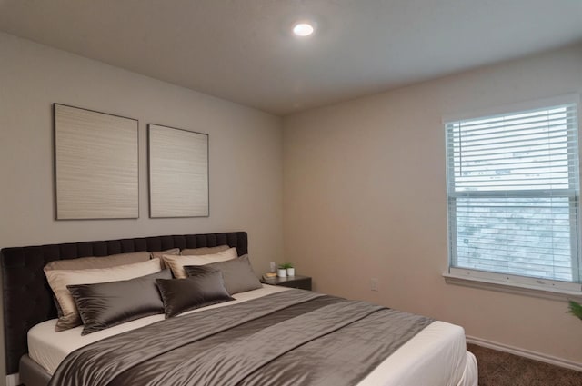 bedroom featuring carpet and baseboards