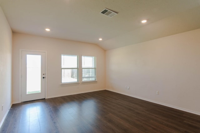 unfurnished room with dark wood-type flooring and vaulted ceiling