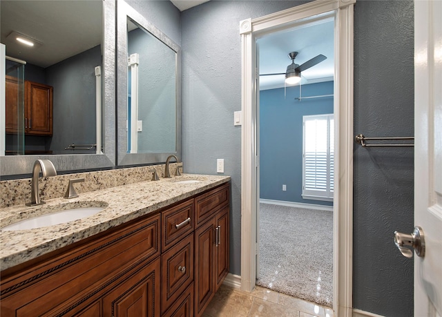 bathroom with tile patterned floors, ceiling fan, and vanity