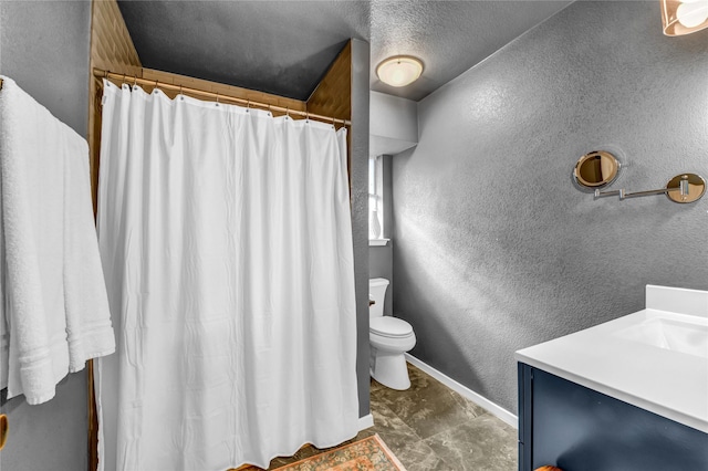 bathroom featuring vanity, toilet, and a textured ceiling