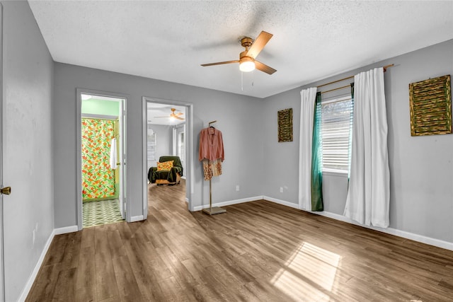 unfurnished room with wood-type flooring and a textured ceiling