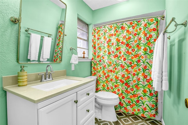 bathroom with vanity, a textured ceiling, and toilet