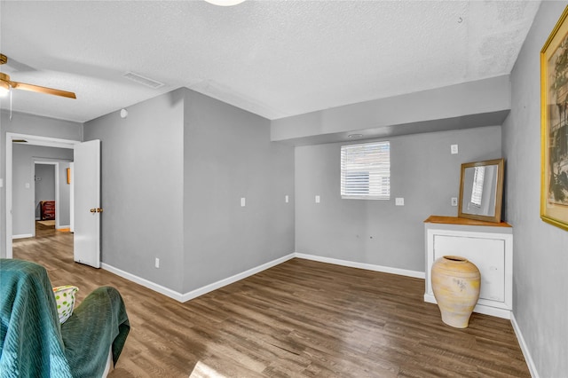 interior space with hardwood / wood-style flooring, ceiling fan, and a textured ceiling