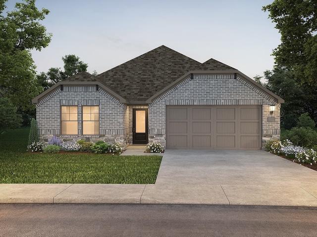 view of front of home featuring a garage and a front yard