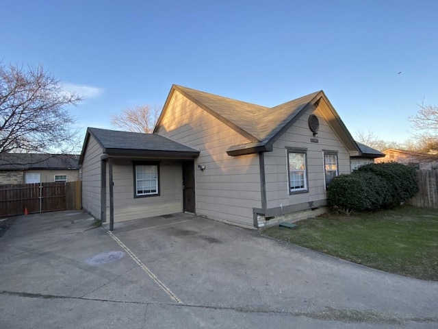 view of side of home with a yard