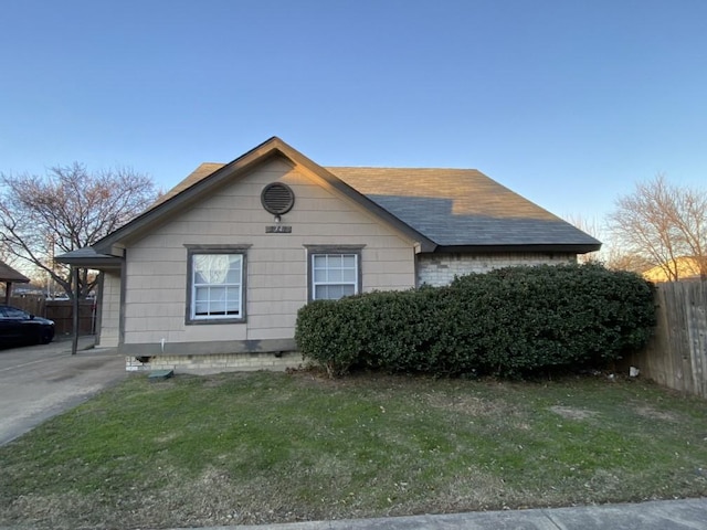 view of side of home with a lawn