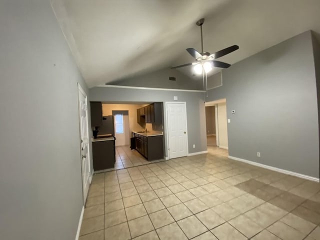 interior space with high vaulted ceiling, ceiling fan, and light tile patterned flooring