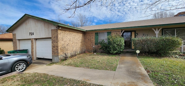 ranch-style house featuring a garage and a front yard