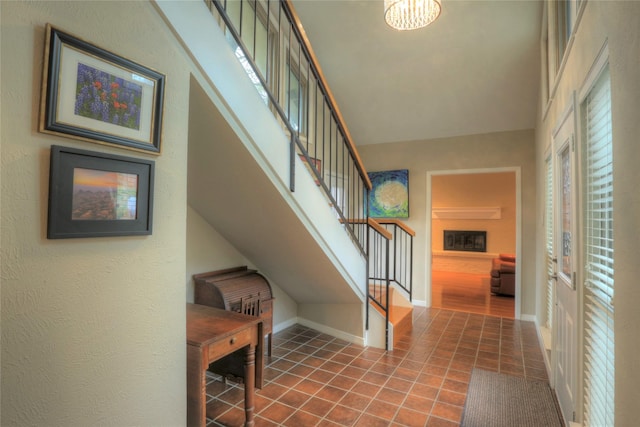 staircase with tile patterned flooring and a chandelier