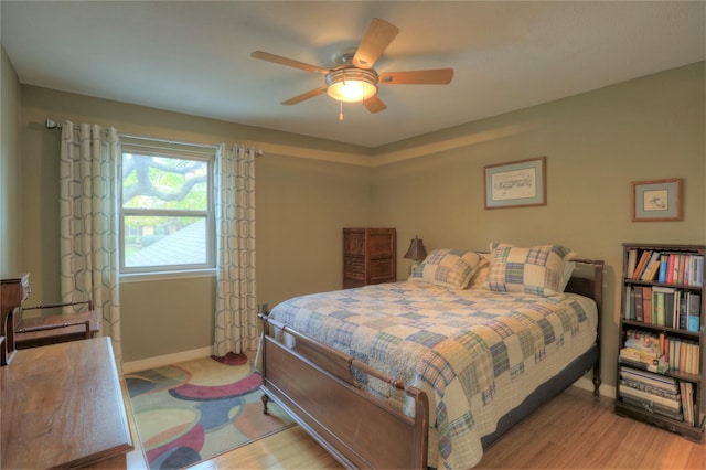 bedroom featuring light hardwood / wood-style floors and ceiling fan