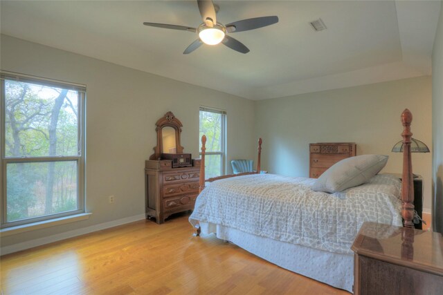 bedroom with light hardwood / wood-style flooring and ceiling fan