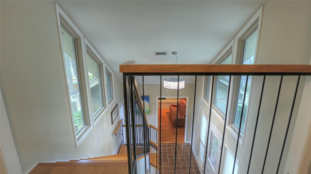 hall featuring a chandelier