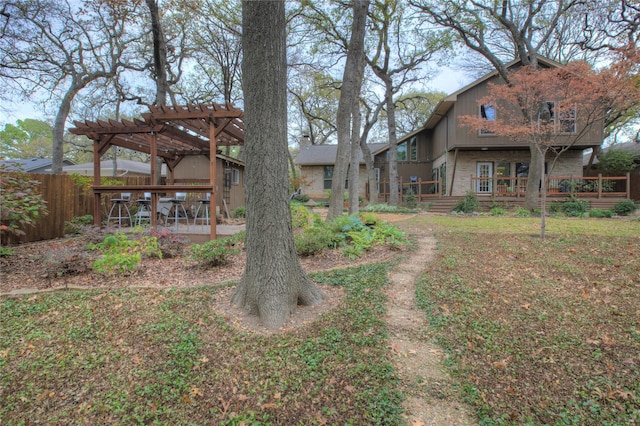 view of yard featuring a deck and a pergola