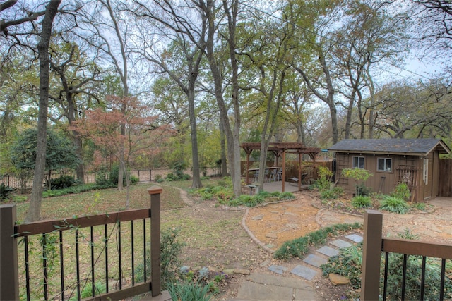 view of yard with a pergola, a patio area, and a storage shed