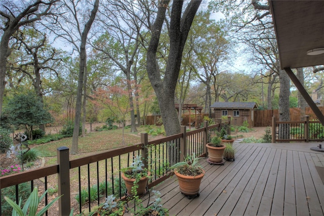 wooden deck featuring a storage unit