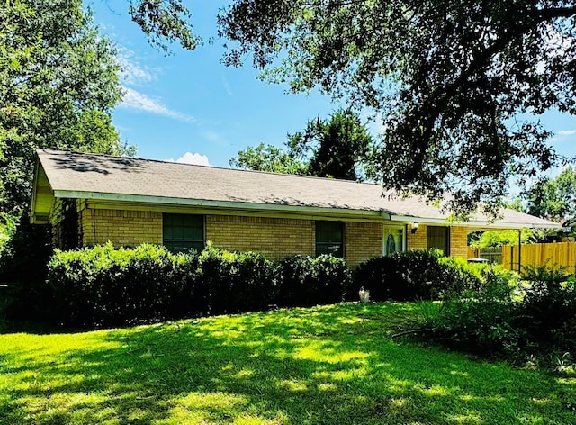 view of side of home featuring a lawn