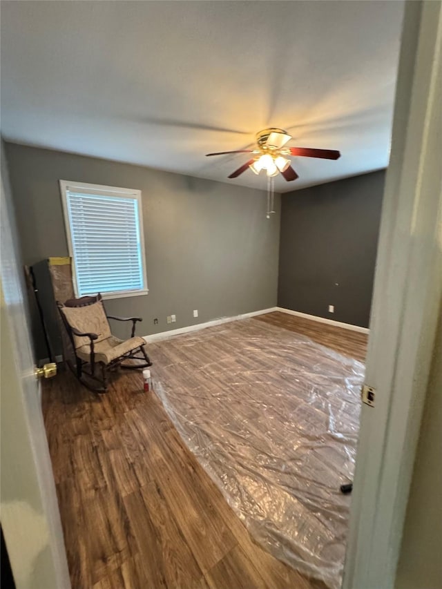 unfurnished room with hardwood / wood-style floors and ceiling fan