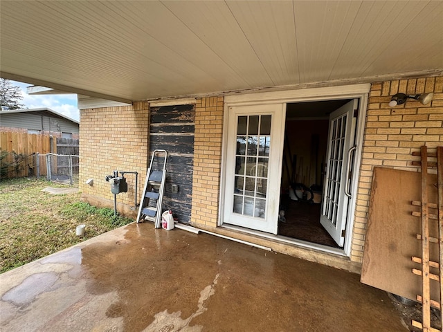 view of exterior entry featuring a patio