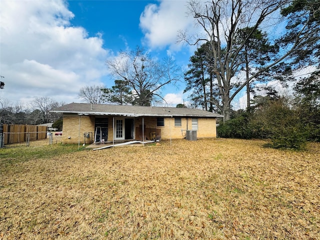 rear view of property featuring central AC, a yard, and a patio area