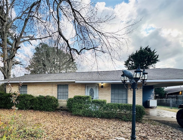 ranch-style house featuring a carport