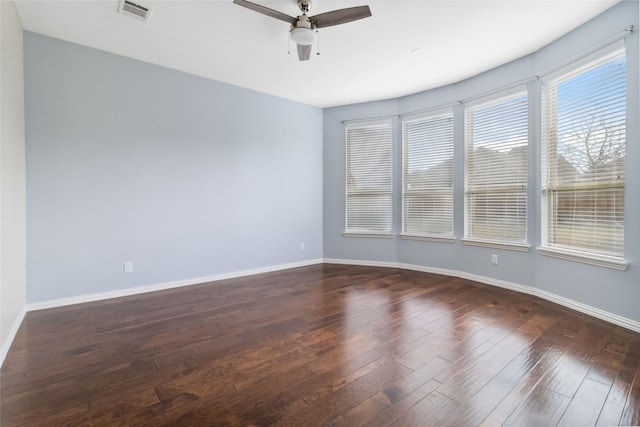 spare room featuring ceiling fan and dark wood-type flooring