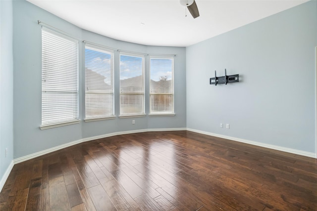 spare room with dark hardwood / wood-style flooring and ceiling fan