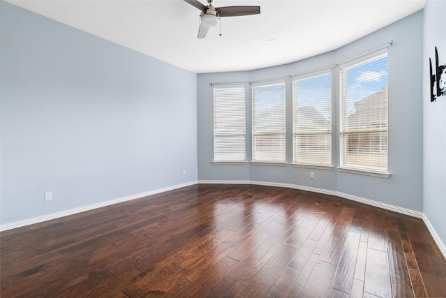 spare room featuring ceiling fan and dark wood-type flooring