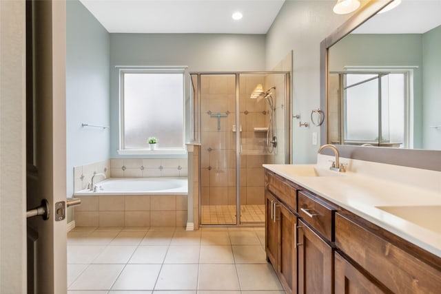 bathroom featuring tile patterned floors, vanity, plenty of natural light, and plus walk in shower