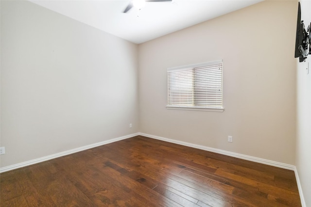 unfurnished room with ceiling fan and dark wood-type flooring