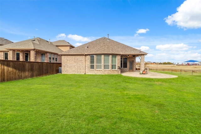 back of property with a patio and a lawn