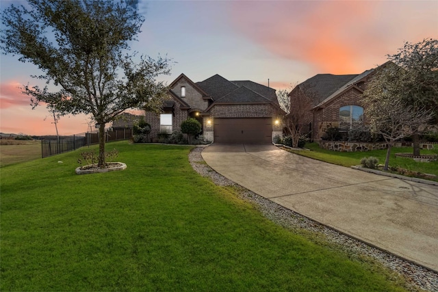 view of front facade featuring a garage and a lawn