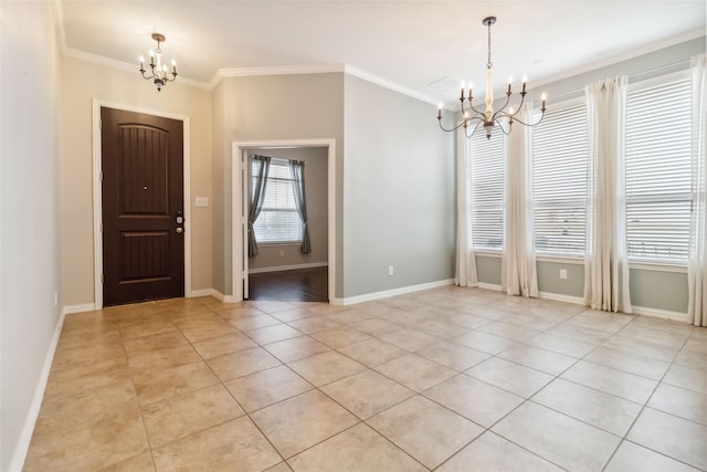 tiled foyer entrance featuring ornamental molding and an inviting chandelier