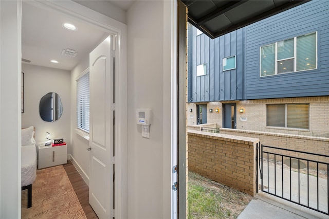 exterior space featuring backsplash and wood-type flooring