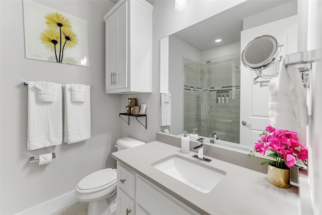 bathroom featuring toilet, vanity, and walk in shower