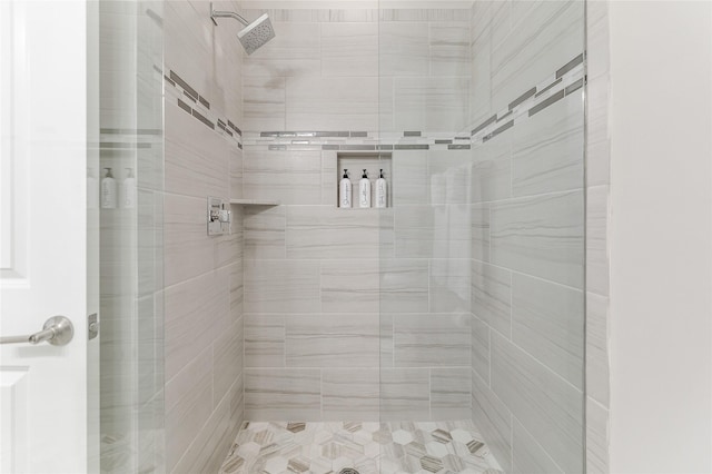 bathroom with a tile shower