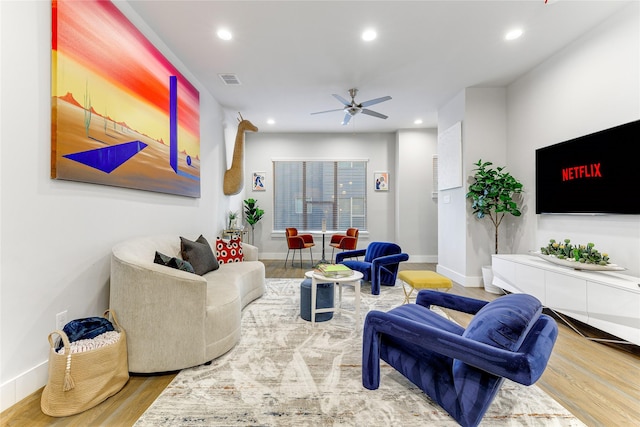 living room featuring hardwood / wood-style flooring and ceiling fan