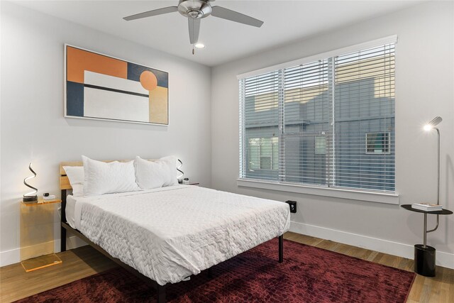 bedroom with hardwood / wood-style floors and ceiling fan