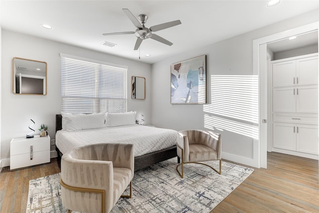 bedroom with ceiling fan and light wood-type flooring