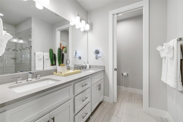 bathroom with vanity and a shower with shower door