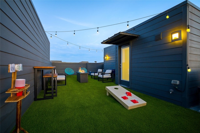 yard at dusk featuring outdoor lounge area