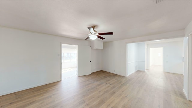 empty room with ceiling fan and light hardwood / wood-style flooring