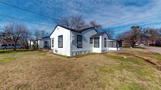 view of side of home with a yard