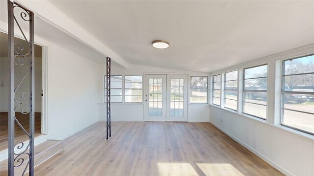 unfurnished sunroom with vaulted ceiling