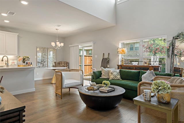 living room with a notable chandelier, dark hardwood / wood-style floors, and a wealth of natural light