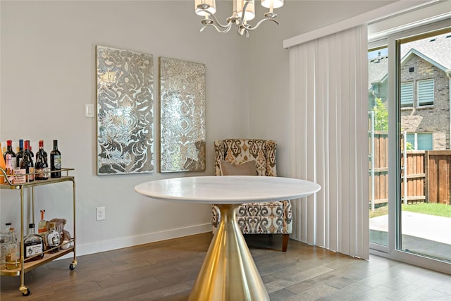 dining area with an inviting chandelier and hardwood / wood-style floors