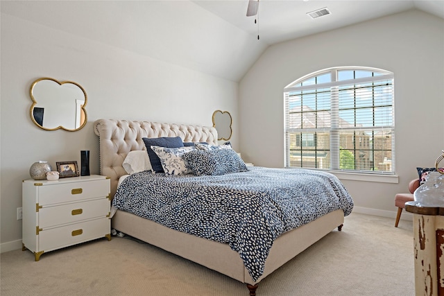 bedroom featuring multiple windows, vaulted ceiling, light colored carpet, and ceiling fan